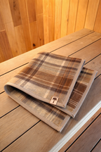sauna mat nz wool brown plaid on wooden bench