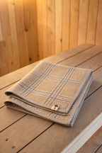 Sauna mat NZ wool beige plaid on wooden sauna bench