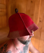 person wearing a red sauna hat nz wool in the sana