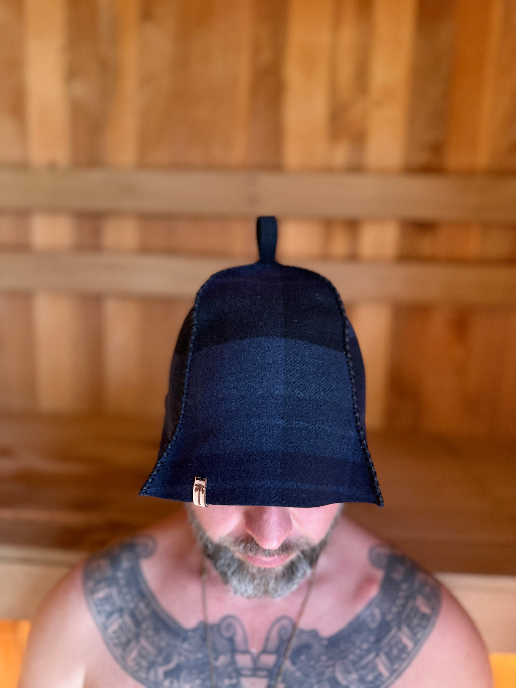 person wearing sauna hat new zealand wool in the sauna