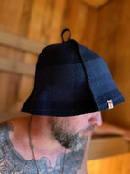person wearing a navy blue sauna hat nz wool