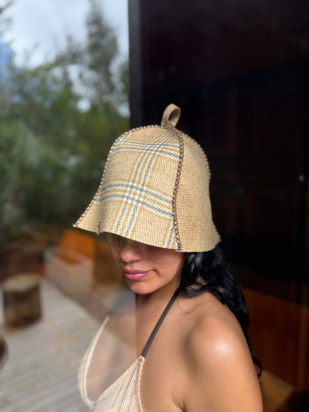 person wearing beige wool sauna hat outdoor