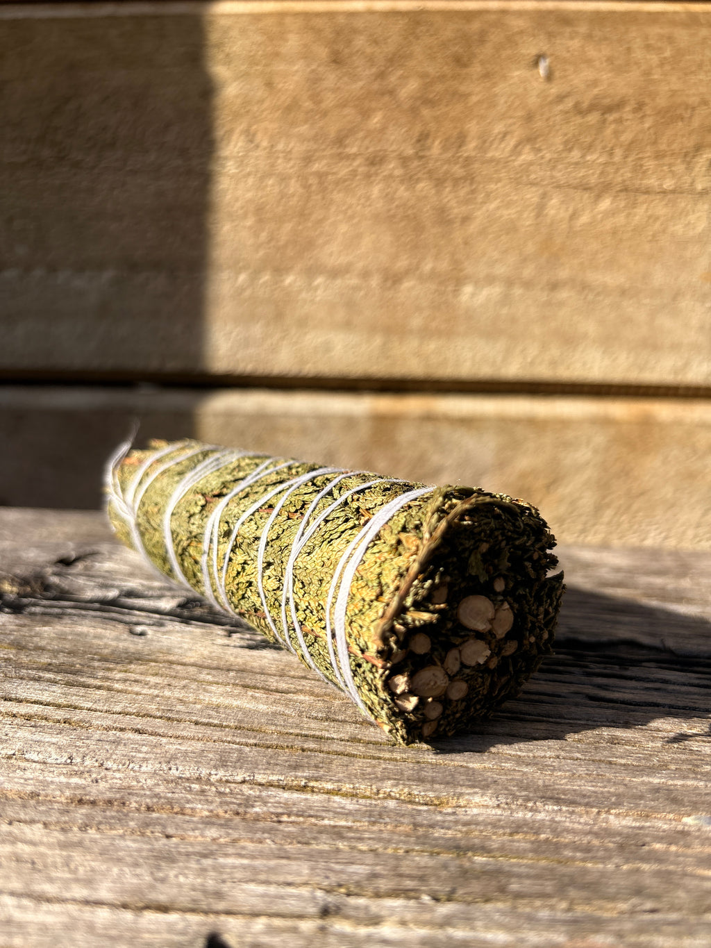 cedar smudge bundle on. a wooden surface