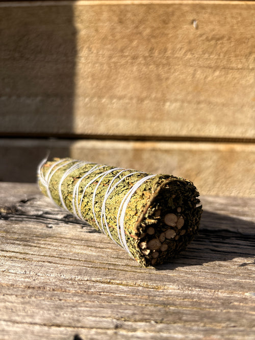 cedar smudge bundle on. a wooden surface