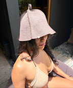 woman wearing a sauna hat nz wool in the sauna