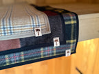 Close up sauna mat NZ wool black and yellow plaid texture
