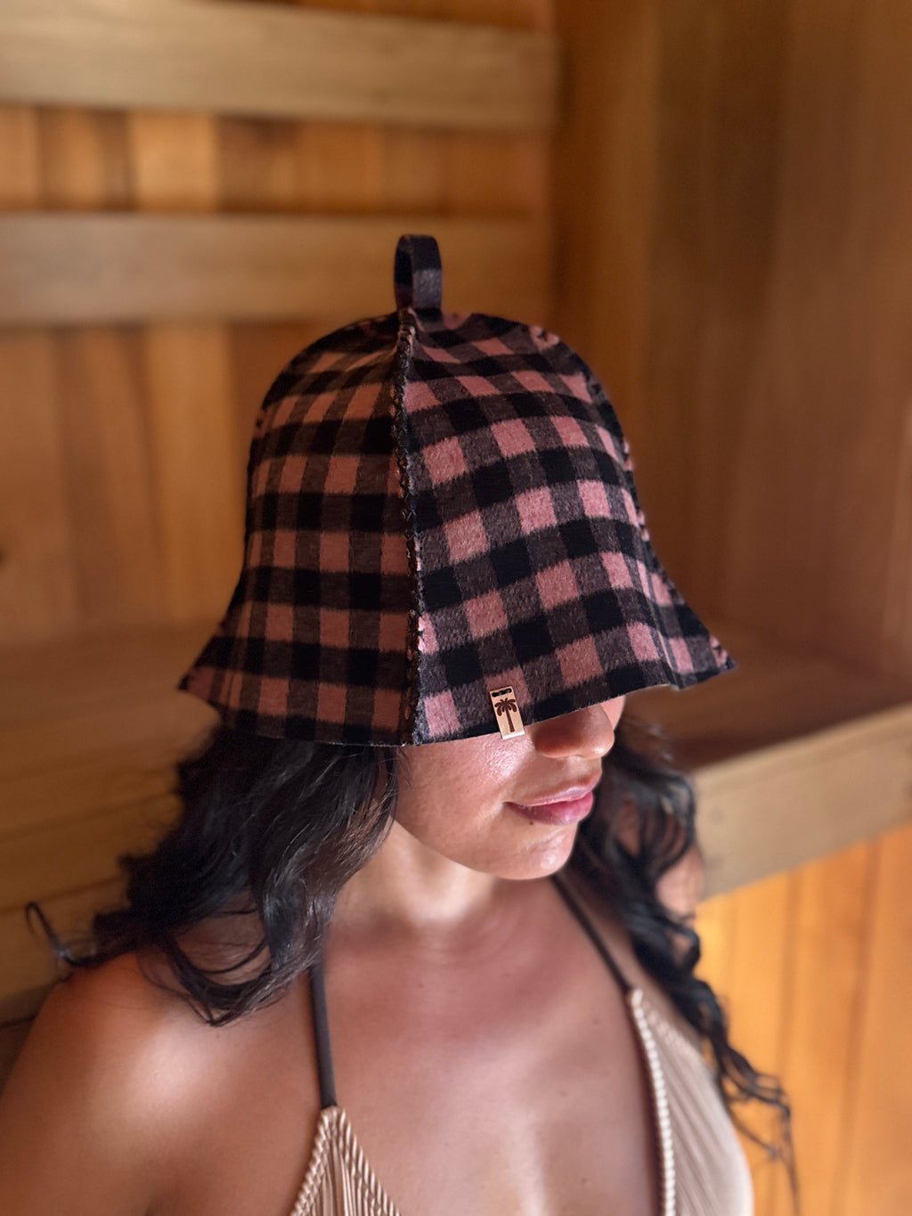 person wearing pink wool suna hat in sauna