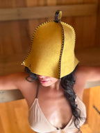 person wearing yellow wool sauna hat nz wool in sauna