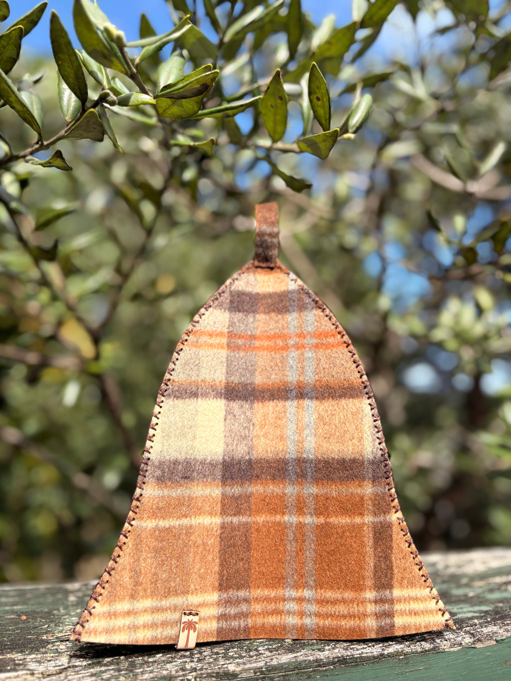 sauna hat nz wool brown plaid in a wooden surface